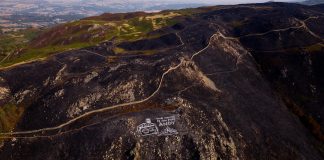 Activists paint giant climate warning to Burnham on mountainside scorched by wildfires