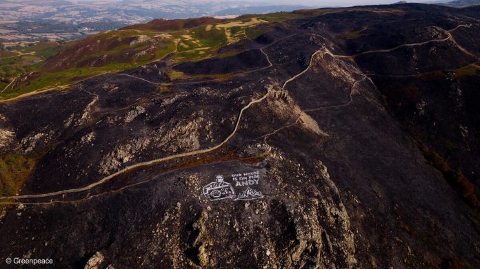 Land artwork “Our House is on Fire” sends powerful message to Andy Burnham